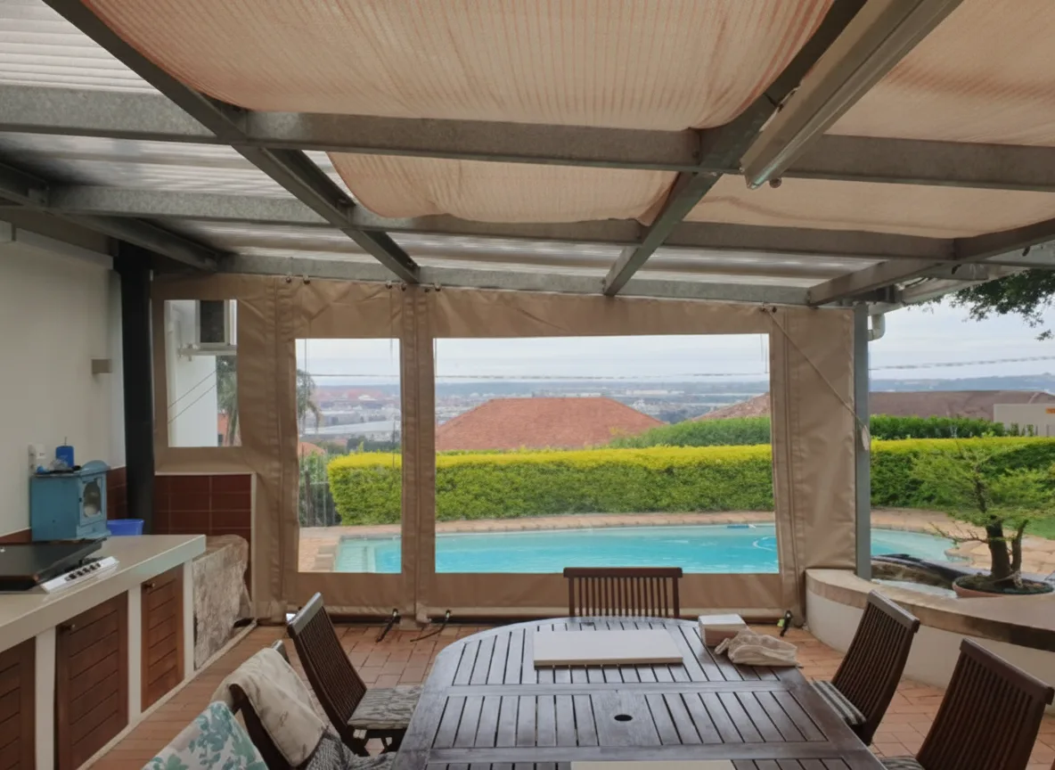 Covered patio with a retractable shade awning and drop-down clear PVC blinds overlooking a pool and valley