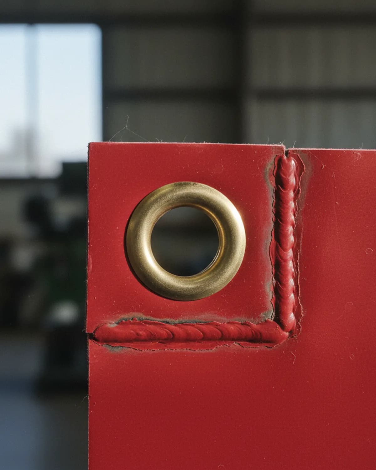 Brass eyelet detail on a finished banner ready for dispatch
