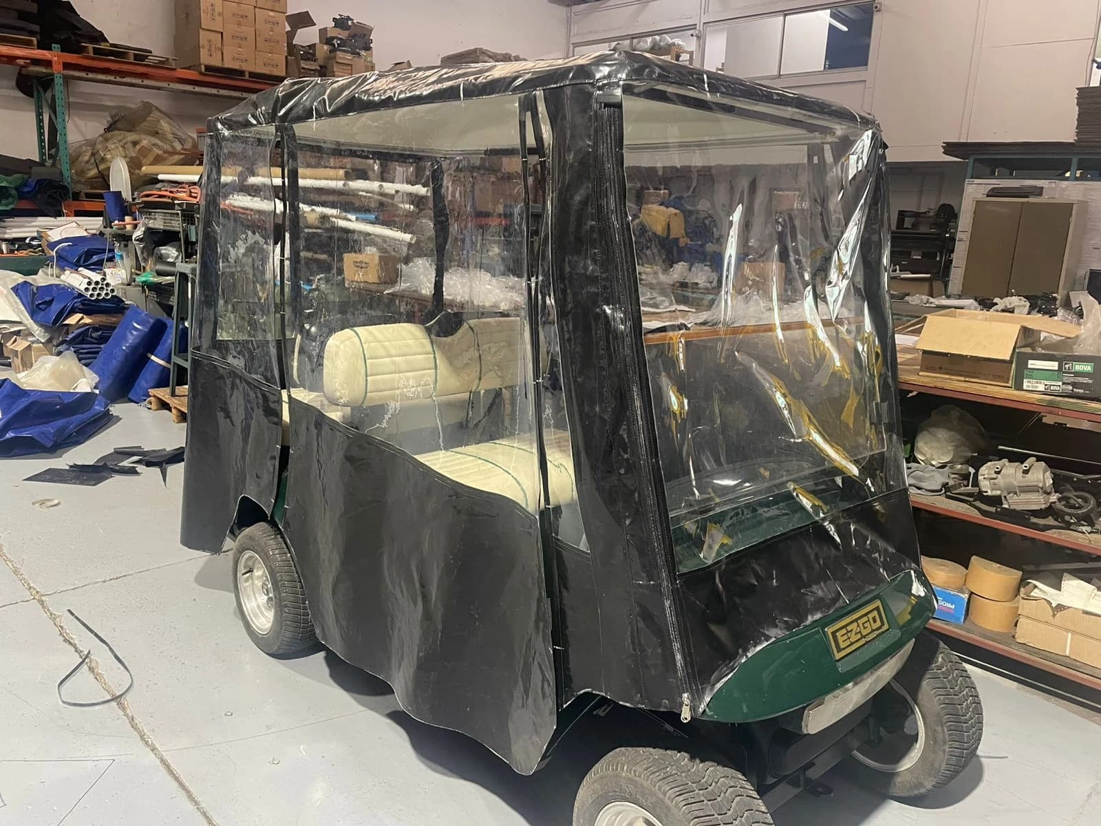 Golf cart fitted with a custom clear PVC enclosure cover