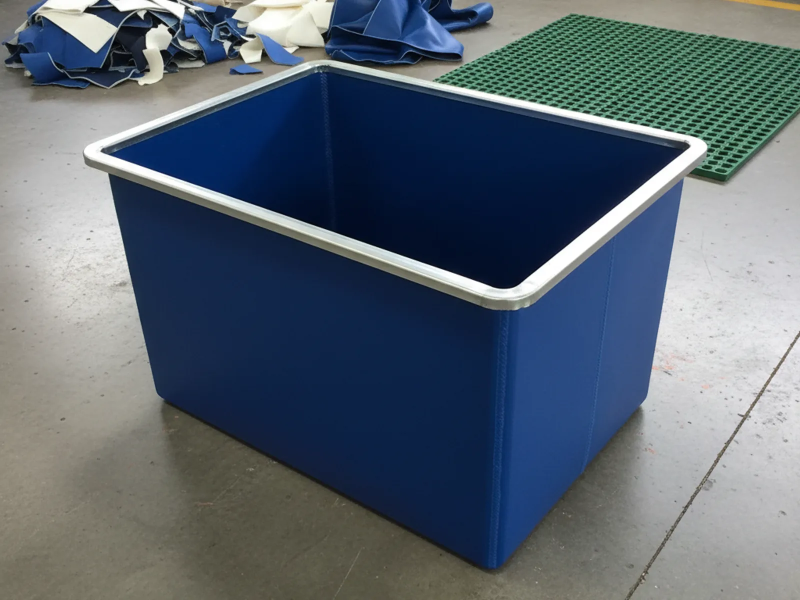 Rectangular cobalt-blue PVC ice bath with galvanised steel rim sitting on the Minurphy Durban factory floor